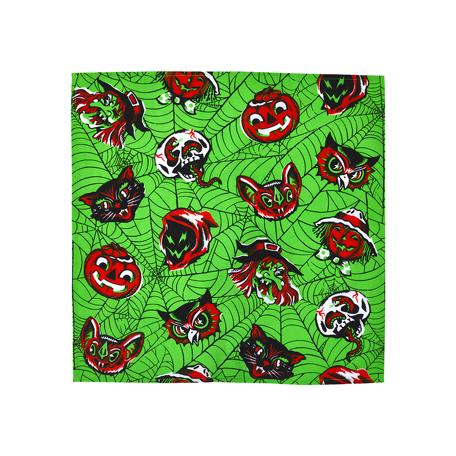 Creep It Real, Comrades. A square fabric wrap featuring a bright lime green cobweb pattern. It is decorated with a repeating vintage-style Halloween motif of red, black, and white pumpkins, witches, bats, owls, skulls, and black cats.